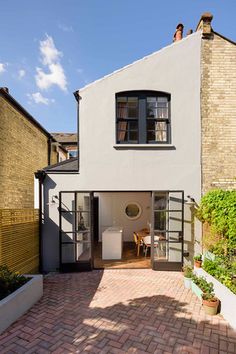 a white house with a brick walkway leading to it