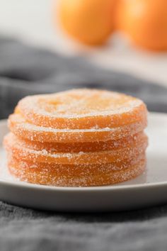 candied orange slices on a white plate with text overlay that reads, candied orange slices