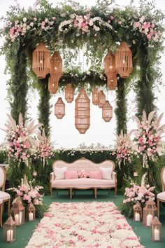 an outdoor wedding setup with pink flowers and greenery