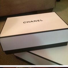 two boxes sitting on top of each other with the word chanel written on them