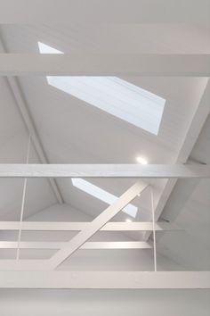 Painted all in white, this is an image of a high raked ceiling clad in v-groove board. The trusses are exposed and two sky windows are recessed into the re-clad ceiling space. The result of this renovation is a light, airy and timeless space. Ceiling Renovation, Rabbit Warren, Federation Home, Exposed Trusses, Raked Ceiling, Herringbone Flooring, V Groove, Tasmanian Oak, Herringbone Floor