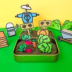 a green tray filled with vegetables on top of a table next to boxes and signs