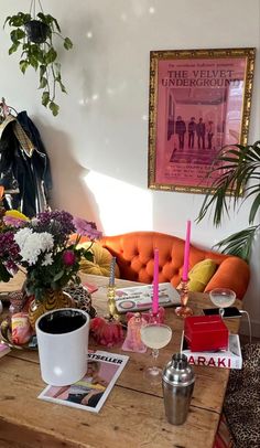 a living room filled with lots of furniture and flowers on top of a wooden table