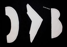 the letters are cut out and placed next to each other on a black background with white stitching