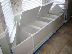 a room with some white boxes on the floor and blinds in the window sill