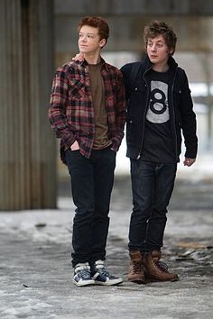 two young men standing next to each other