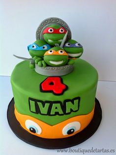 a birthday cake with three teenage mutant ninja turtles on it's top and the number four