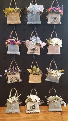 several small bags with flowers hanging from them