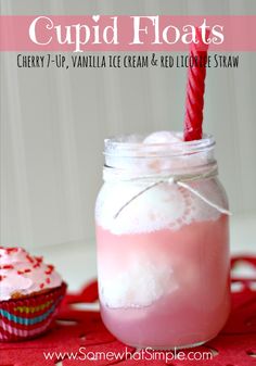 a cupid float in a mason jar with a red straw