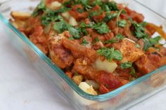 a glass casserole dish filled with meat and vegetables