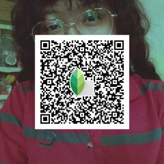 a person wearing glasses and a red shirt has a qr code on their face