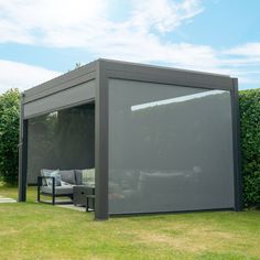 an outdoor living area in the middle of some grass