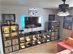 a living room filled with furniture and a flat screen tv on top of a entertainment center