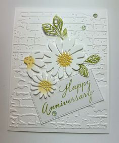 an anniversary card with flowers on it