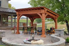 a patio with an outdoor fireplace and seating area