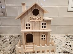 a wooden birdhouse sitting on top of a counter