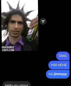 a man with long hair is talking to someone on his cell phone while wearing a purple shirt