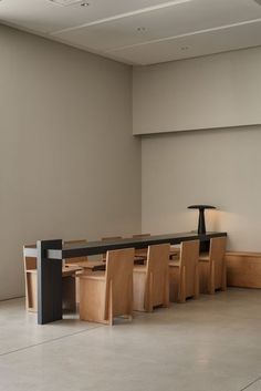 an empty room with several tables and chairs in it, all lined up against the wall