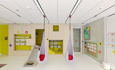 two hammocks hanging from the ceiling in a room with children's toys