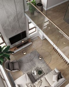 an aerial view of a living room and staircase