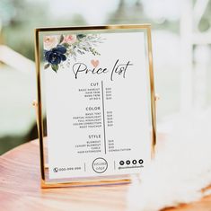 a price list on a wooden table with flowers