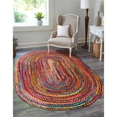 a living room with a chair and rug on the floor