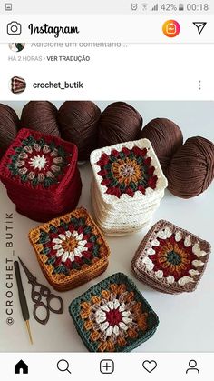 there are crochet squares and yarns on the table