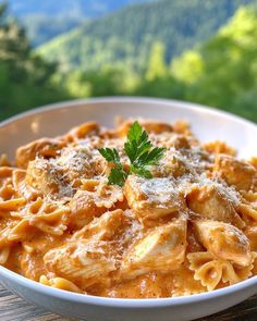 a white bowl filled with pasta and sauce