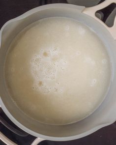 a pot filled with liquid sitting on top of a stove