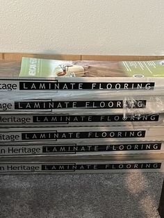 a stack of books sitting on top of a wooden table