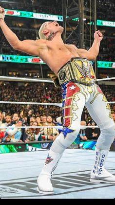 an image of a wrestler in the middle of a wrestling ring with his arms up