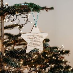 a wooden star ornament hanging from a christmas tree