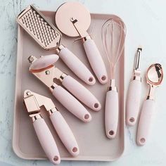 the kitchen utensils are laying out on the tray