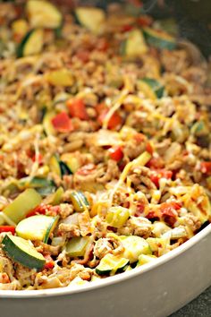 a casserole dish with zucchini, meat and vegetables