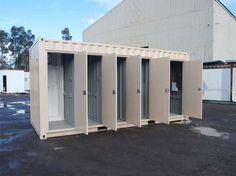 several portable toilets are lined up in a parking lot