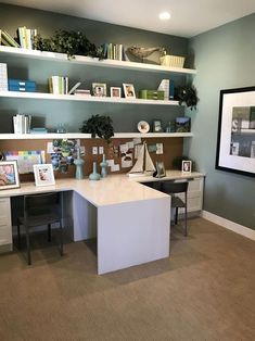 a home office with two desks and bookshelves