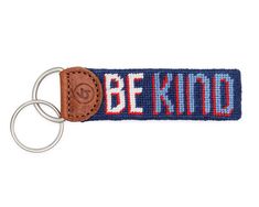 a key chain with the words be kind on it