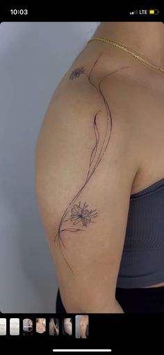 a woman's shoulder with a flower tattoo on it