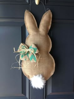 a burlap bunny head hanging on the front door