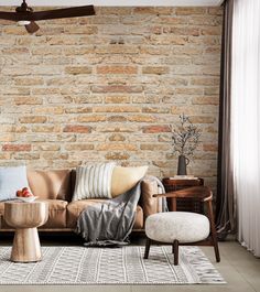 a living room filled with furniture and a brick wall