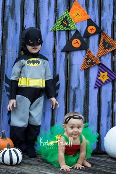 two children dressed up as batman and catwoman