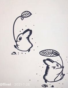 an ink drawing of two animals with leaves on their heads