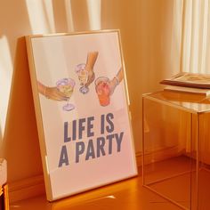 there is a sign that says life is a party next to a table with drinks on it