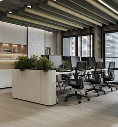 an office with desks, chairs and planter in the middle of the room