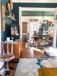 a living room filled with furniture and a flat screen tv sitting on top of a wooden table