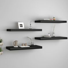 three black floating shelves on the wall