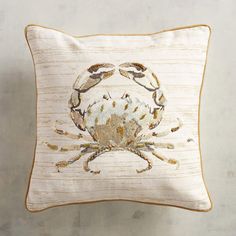 an embroidered crab pillow on a white background