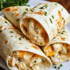 chicken and cheese burritos on a white plate