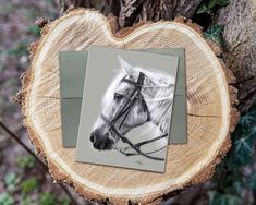 a white horse is shown on a piece of wood next to an image of it's head