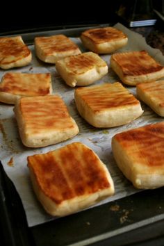 there are many pieces of bread on the baking sheet